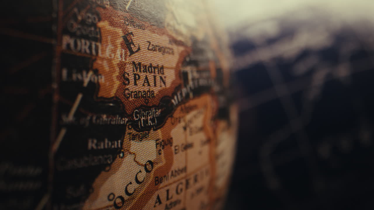 Close-up of a vintage-style globe highlighting the region of Spain and surrounding countries