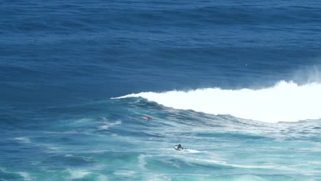 wave breaks in front of a surfer