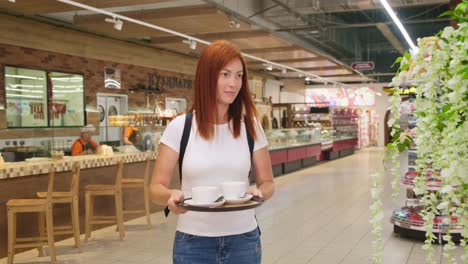 mother and daughter having coffee in grocery store cafe
