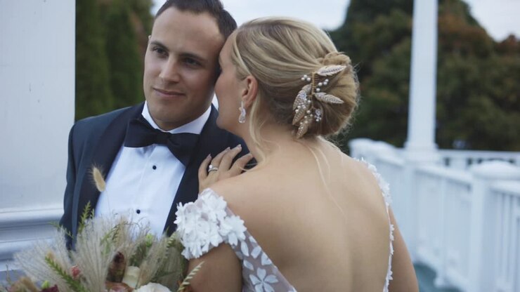 Bride and groom stand romantically at luxury hotel
