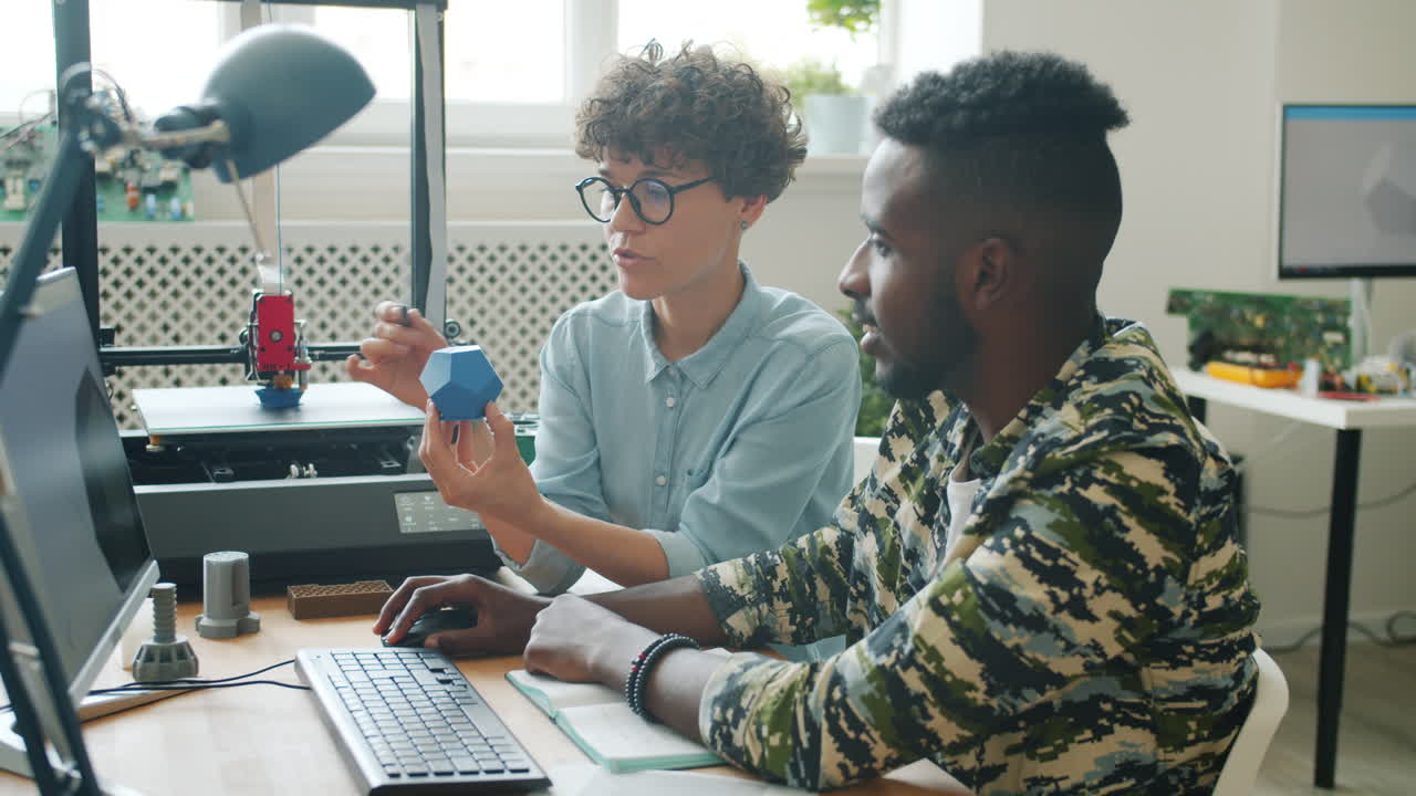 Two students collaborating on a 3D printed model