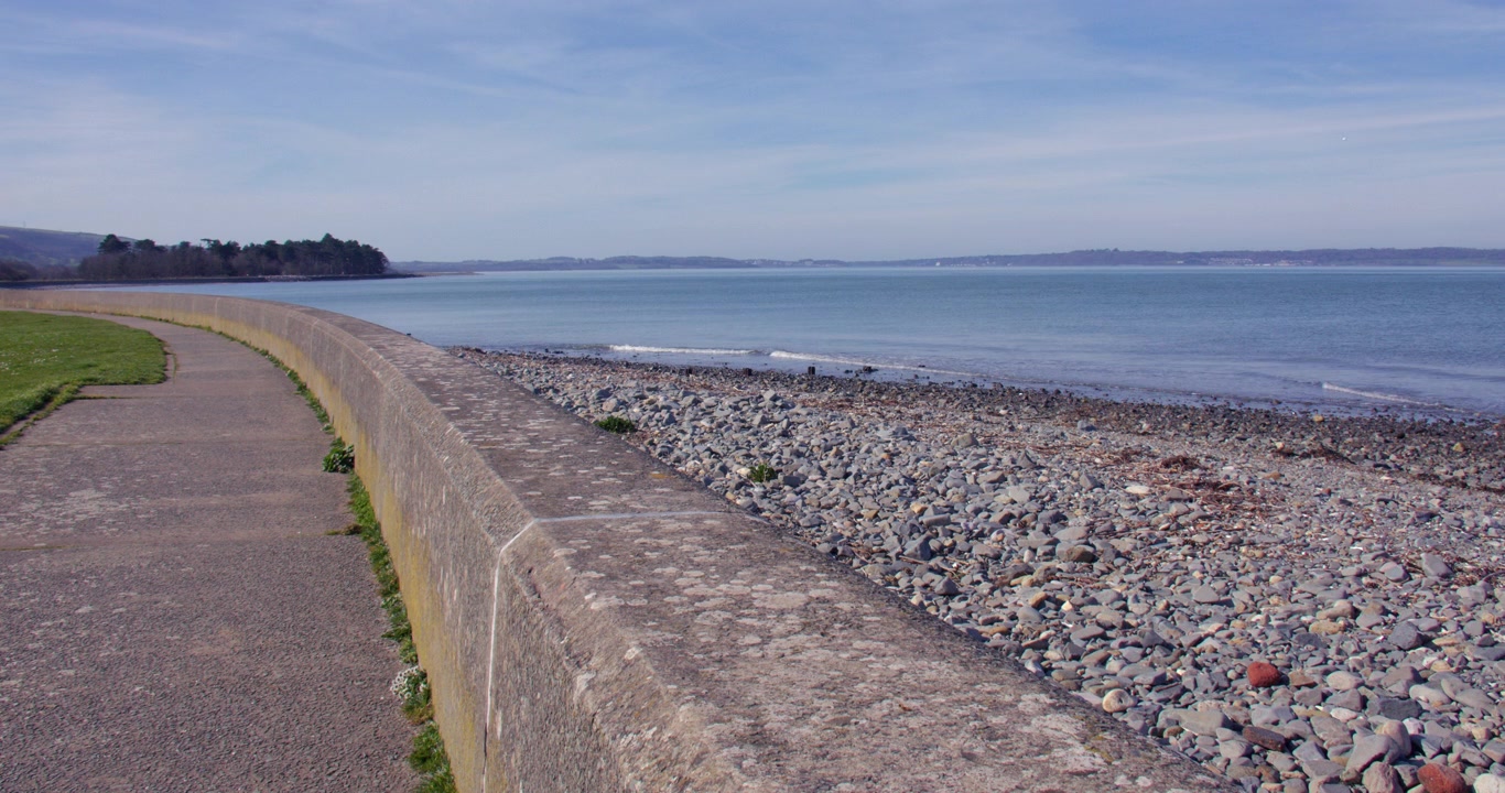 Shot looking south west up the sea wall and Promenade at Llanfairfechan with Penmaen Mawr in background