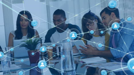 animation of network of digital icons against team of diverse colleagues using electronic devices