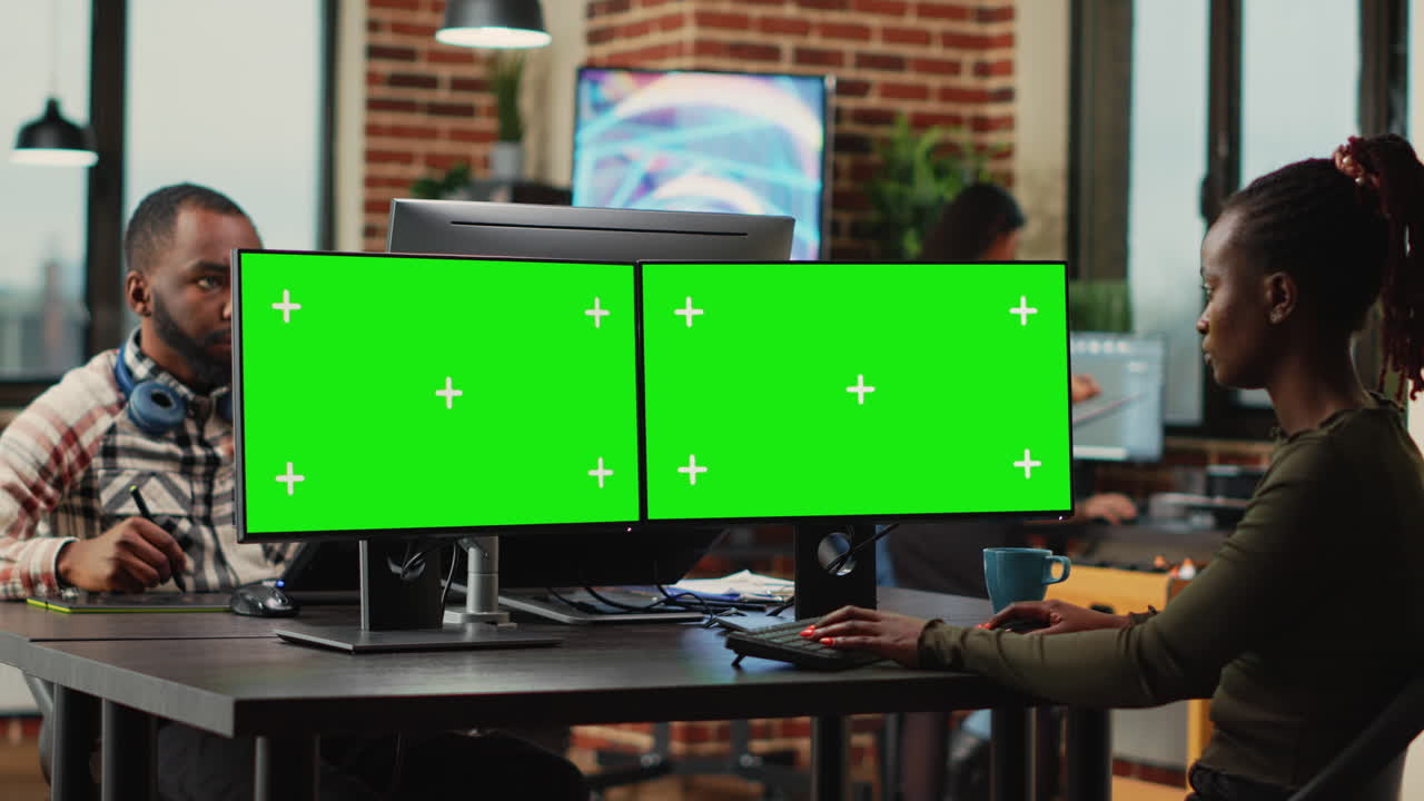Creative agency employee using greenscreen display on computer