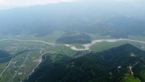 planeadores volando sobre el paisaje brumoso en el himalaya