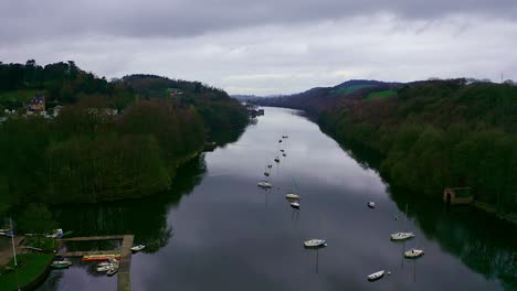 Beautiful-aerial-view,-footage-of-Rudyard-Lake-in-the-Derbyshire-Peak-District-Nation-Park,-popular-holiday,-tourist-attraction-with-boat-rides-and-water-sports-on-off,-peaceful,-calm-water