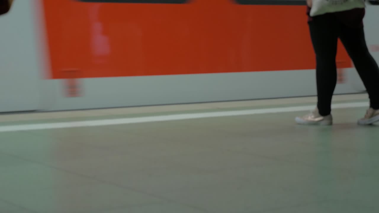 Subway train arriving to the station and people getting in