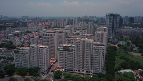 aerial suburban view on sunny day with large apartment and housing development on river