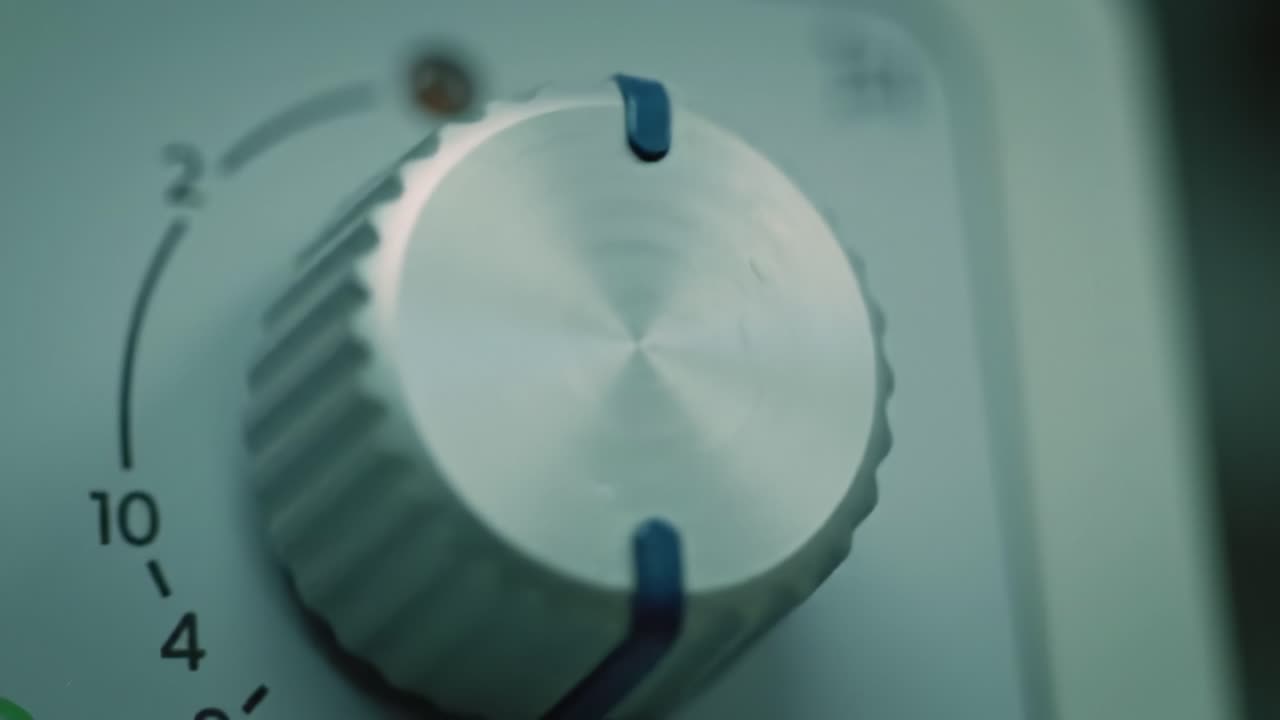 Focus on a metal control knob used to adjust settings on a modern appliance in a home improvement context. The setting displayed highlights the importance of precision in DIY tasks.