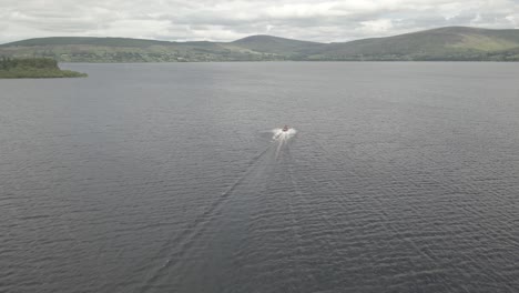 Speedboat Cruising And Leaving Wake On Water Surface Of Blessington Lake In Wicklow, Ireland With Overcast
