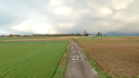 Cinematic-drone-shot-of-a-field-at-golden-hour-during-stormy-weather