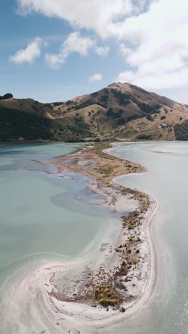 aerial view of a coastal bay with a sandbar and surrounding hills