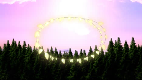 animation of fairy light frame with copy space over fir trees and winter scenery