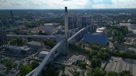hard coal fired power station transporting coal on conveyor belts, showcasing industrial infrastructure in a city. smooth aerial view flight panorama overview drone