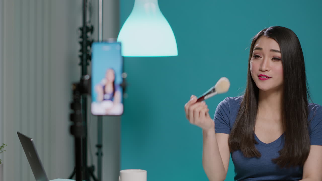 Beauty influencer filming makeup brush review on camera