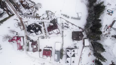 Top-down-drone-shot-of-snow-falling-down-in-Zakopane-in-winter-time