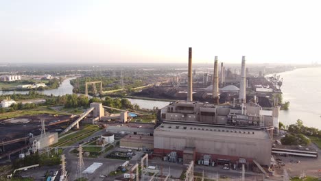 smokestacks with blinking lights at dte coal power plant in rouge river, detroit, michigan - drone pullback