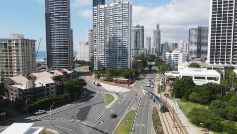 modern electric tram travelling along the gold coast city light rail system towards the surfers paradise tourist precinct