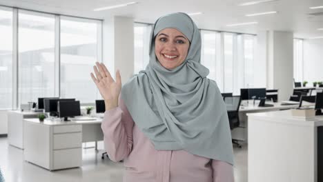 happy muslim businesswoman saying hi