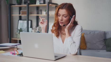 successful caucasian woman in headset with mic talks and gestures with hands