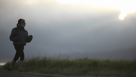 A-young-woman-exercises-at-the-side-of-a-road