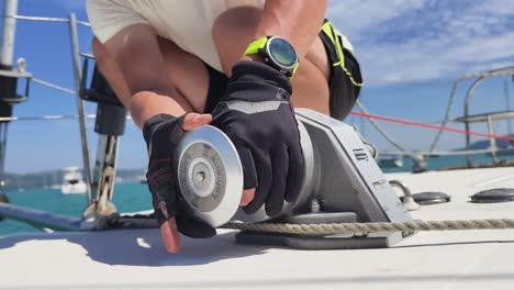 sailor working on boat winch