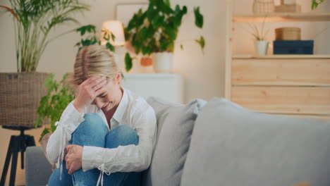 unhappy broken woman on sofa
