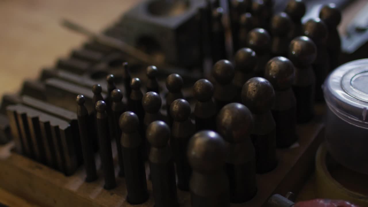 Close up of diverse jeweller tools lying on desk in workshop