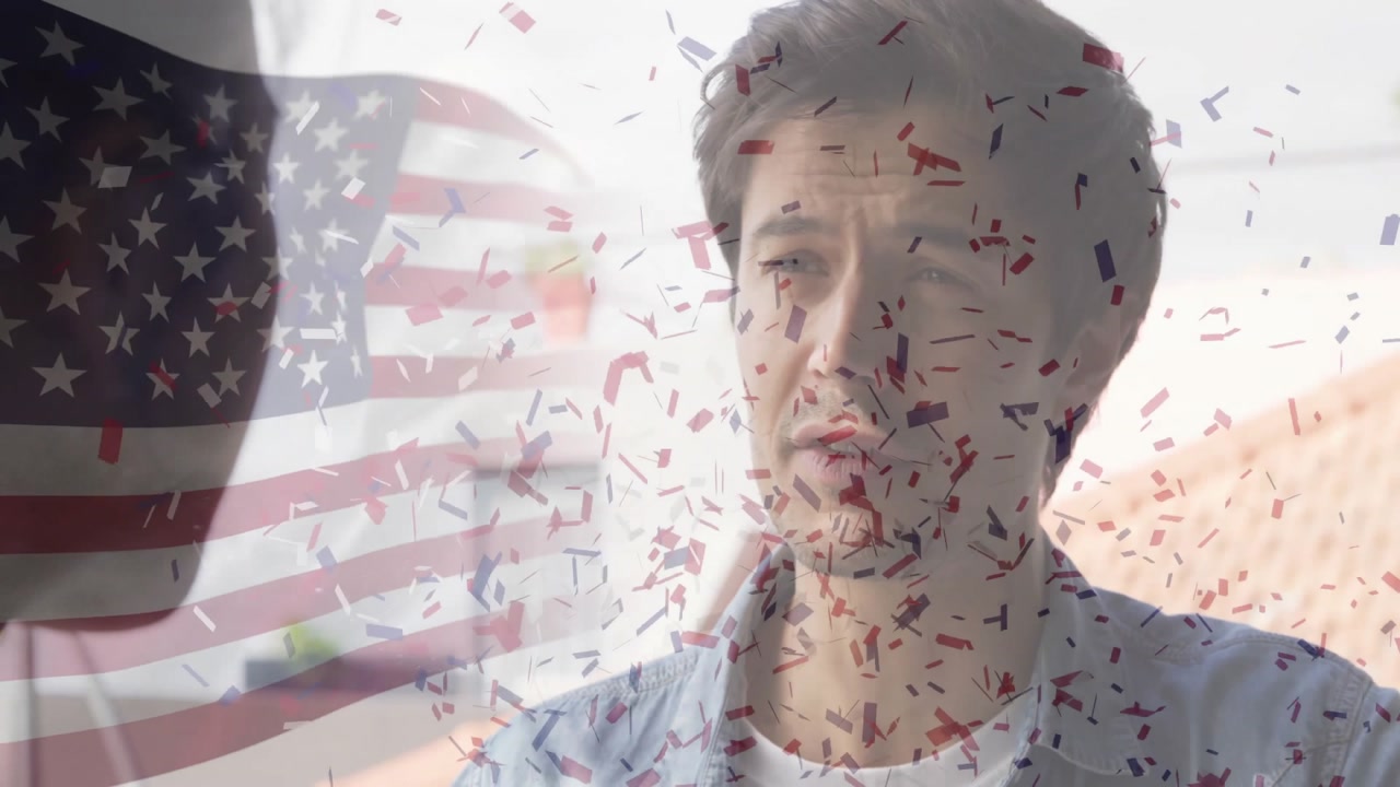 Man at desk sharing marketing as patriotic confetti bursting over face with flag celebrating pride
