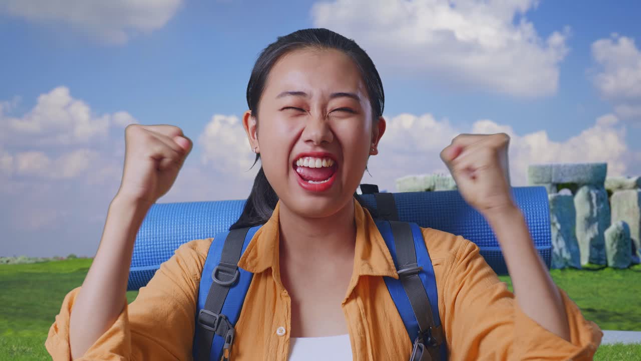 Close Up Of Asian Female Hiker With Mountaineering Backpack Screaming Goal Celebrating The Success While Traveling In Stonehenge