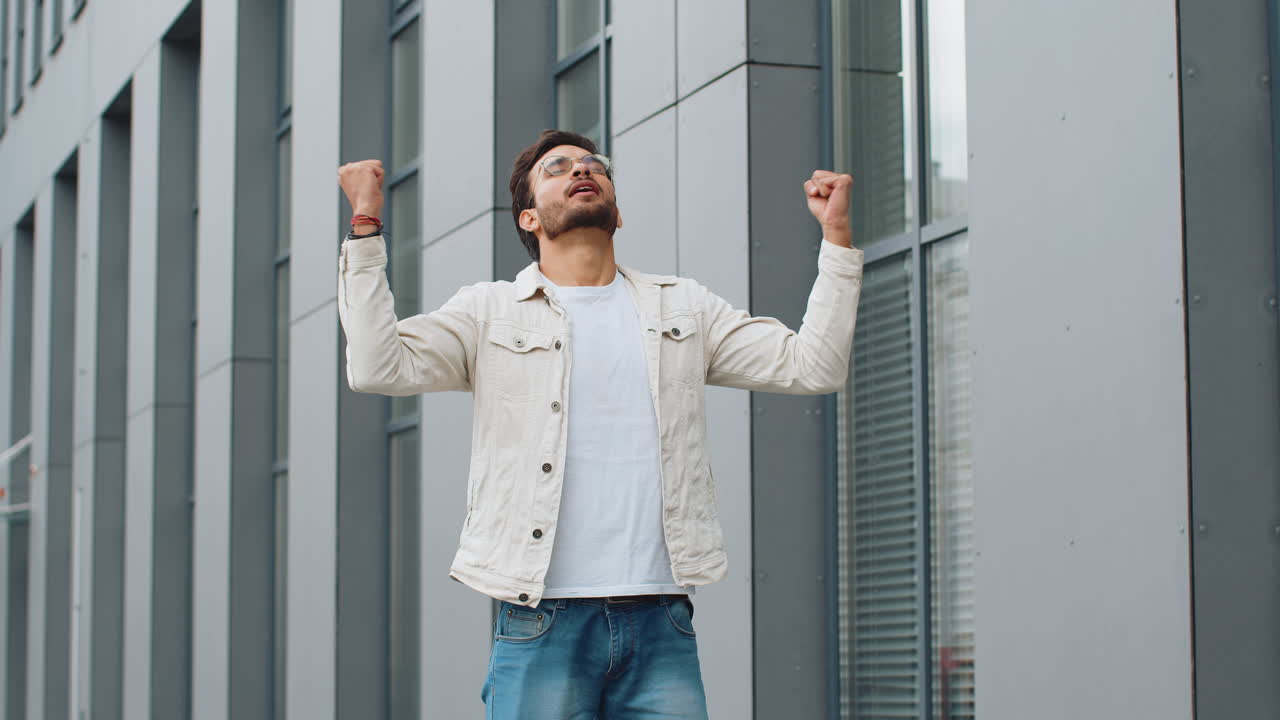 Indian man taking a deep breath of fresh air relaxing taking a break resting meditating outdoor