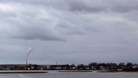 an aerial time lapse of a marsh on a cloudy day with gray skies