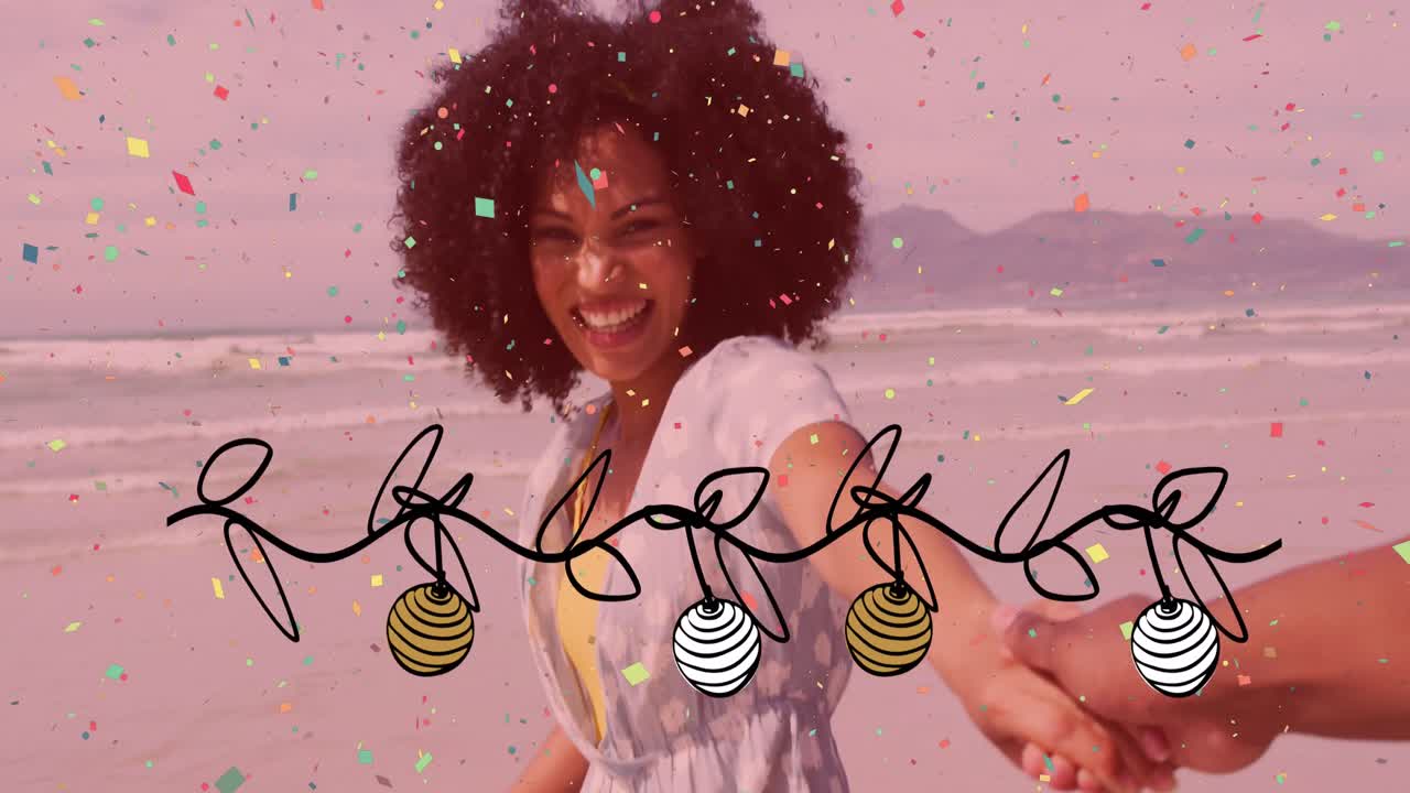 Animation of christmas confetti and decorations over happy biracial woman laughing on sunny beach
