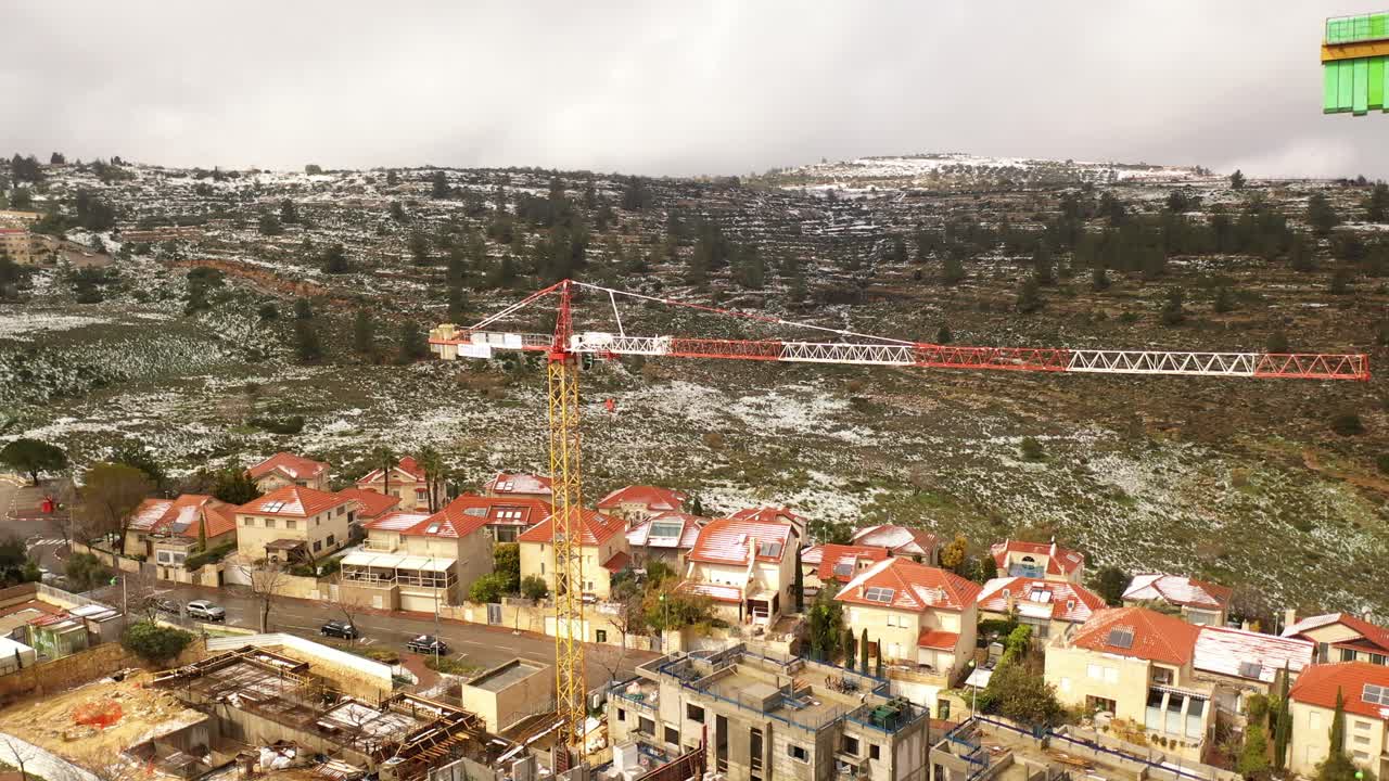 Snowy Residential Area with Construction Crane