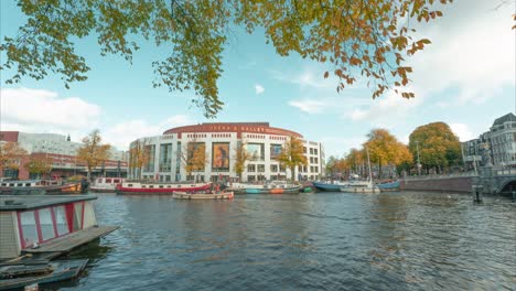 ultra wide angle 4k time lapse view of opera house amsterdam, netherlands on bright sunny autumn day