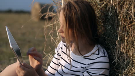 young woman with touch pad in the countryside