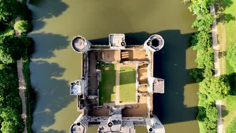 drone-shot footage of bodiam castle offers timeless visuals for creators. epic, cinematic overhead view of castle, bridge walk and moat.