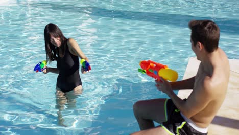 Adults-shooting-shooting-water-guns-at-each-other