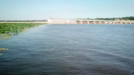 aerial view of lock and dam 14 on the mississippi river with a patch of lily pads in view