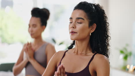 two women meditating in yoga class
