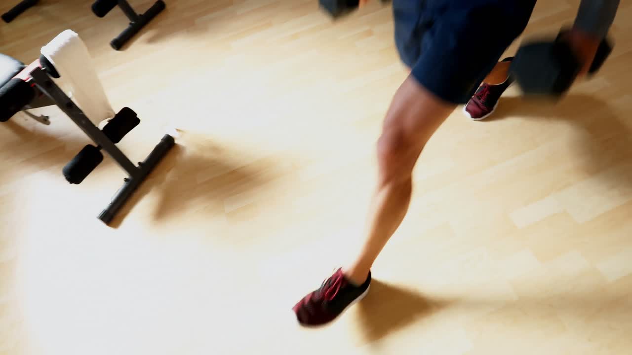 Man exercising with dumbbells 4k