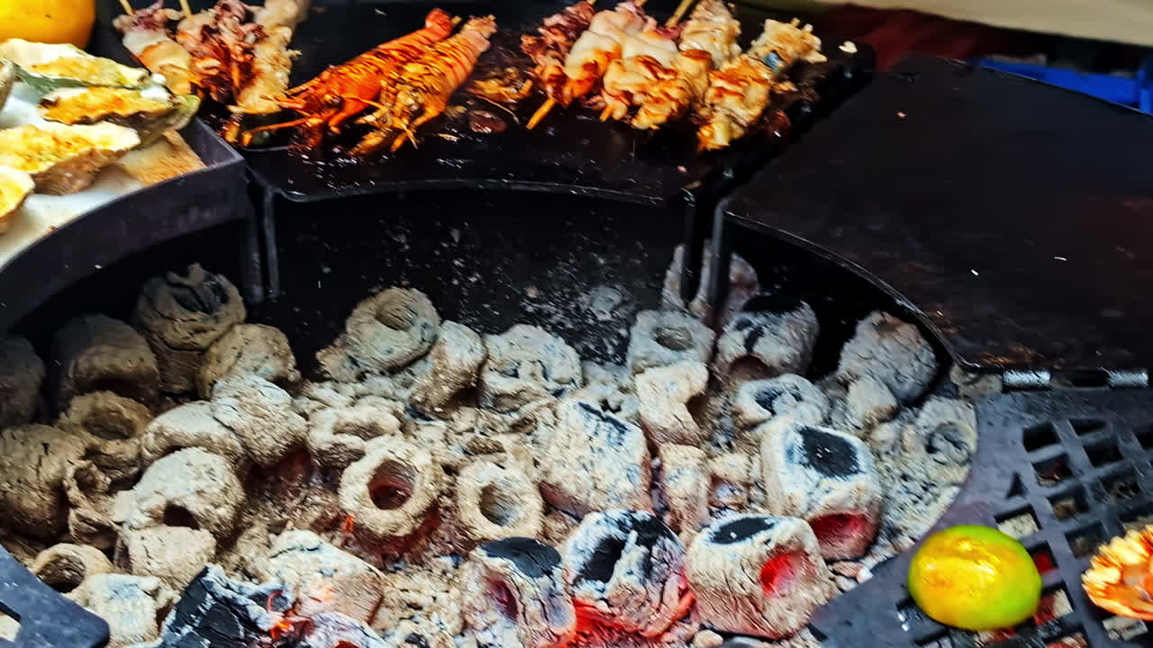 Grilled seafood with oysters, lobster, and skewered meat on the BBQ grill