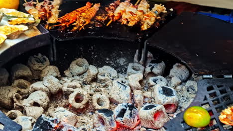 grilled seafood with oysters, lobster, and skewered meat on the bbq grill