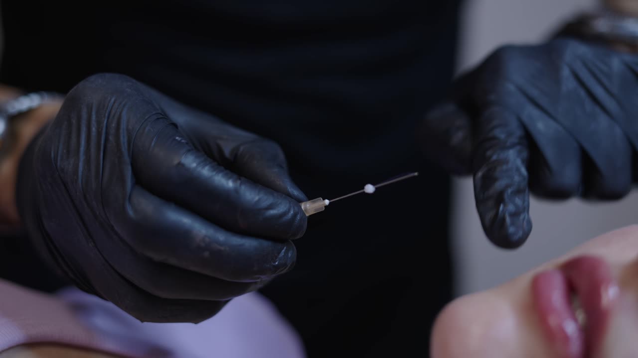 Close-up of gloved hands preparing for a cosmetic procedure