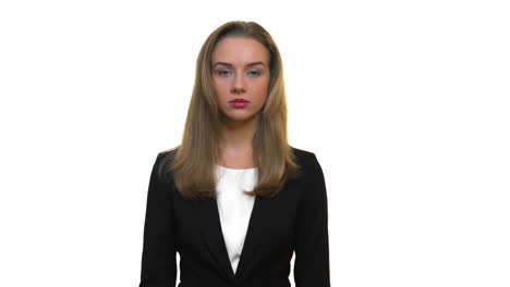 A-close-up-of-a-woman-wearing-business-attire,-staring-into-the-camera-with-a-neutral-expression,-on-a-seamless-white-studio-background