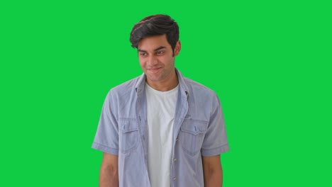 cute young shy indian boy green screen