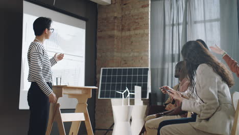 asian woman presenting portable solar charger on conference