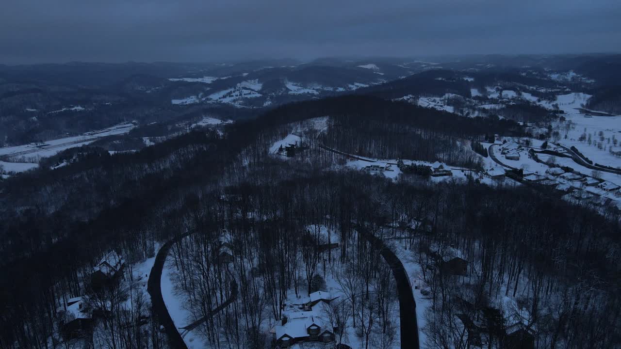Aerial View of a Snowy Mountaintop Community at Night