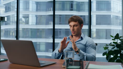 Closeup-stressful-boss-calming-down-in-office.-Man-meditating-at-workplace