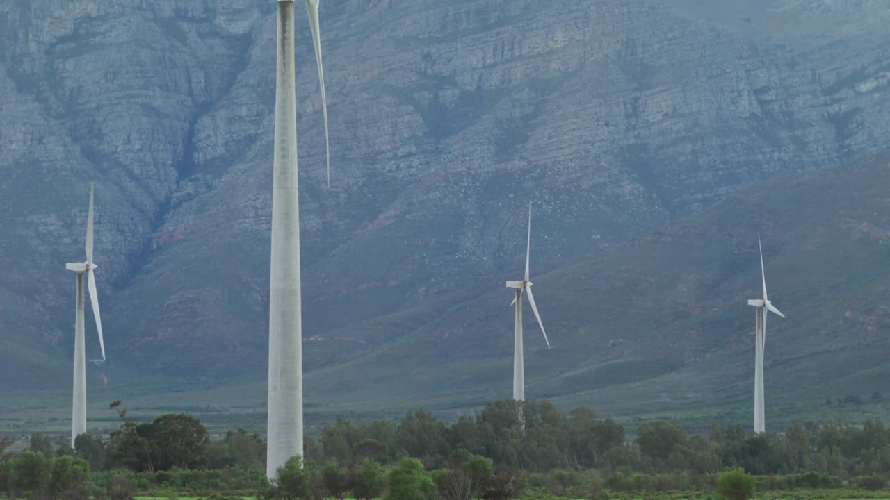 Incoming data stream arriving, main turbine rotating near mountain while blue overlays showing data